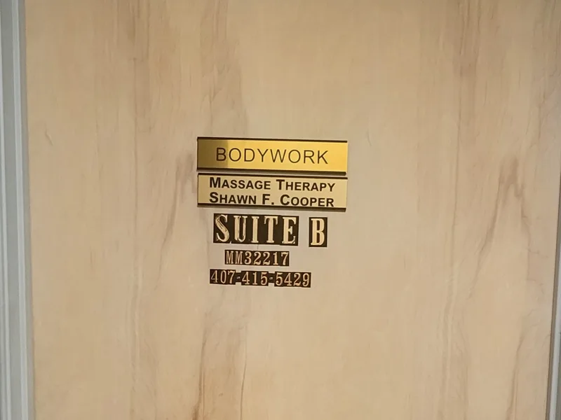 The Suite B door plaque reading Bodywork, Massage Therapy, Shawn F. Cooper
